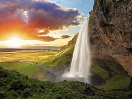 Image of waterfall with sunset in the background